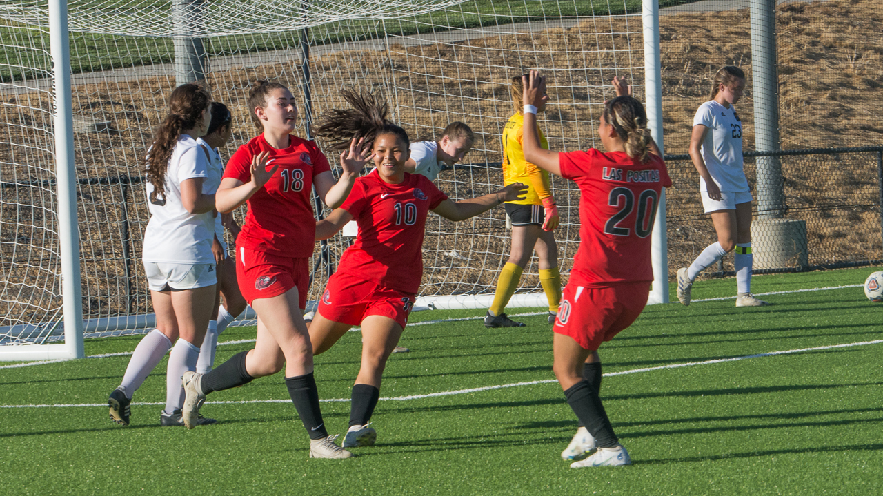 The Hawks celebrate following Alyssa Fitting's (18) goal against Feather River. (Photo by Alan Lewis)
